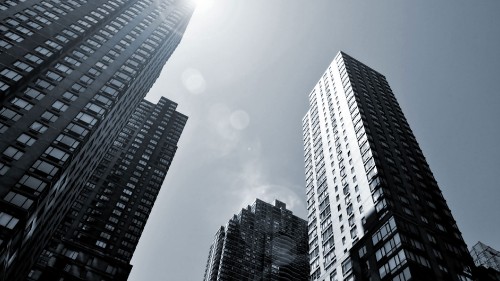 Image low angle photography of high rise buildings under white clouds during daytime