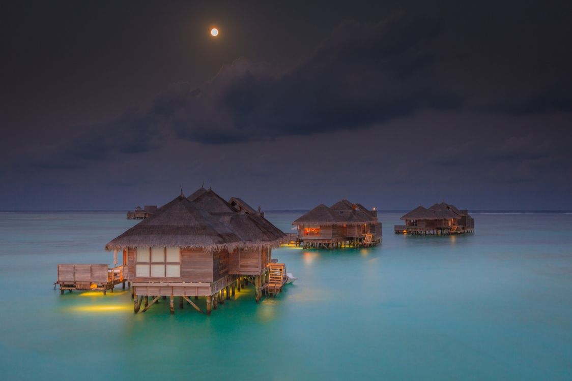 Brown Wooden House on Body of Water During Night Time. Wallpaper in 2048x1366 Resolution