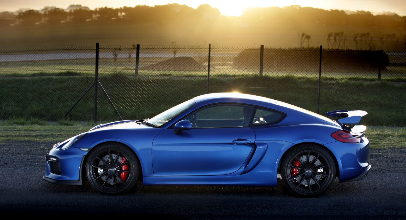 Blue Porsche 911 Parked Near Gray Metal Fence During Daytime. Wallpaper in 6428x3480 Resolution
