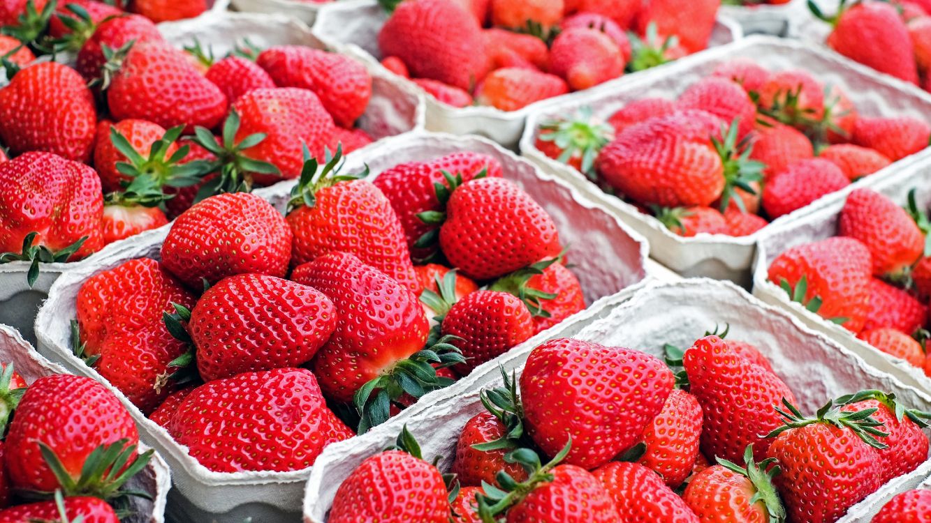 red strawberries on white textile