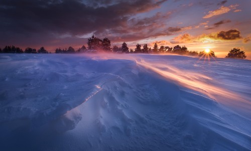 Image white clouds over snow covered field