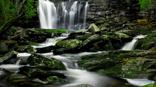 Image water falls on rocky shore during daytime