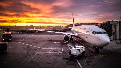 Image white passenger plane on airport during sunset