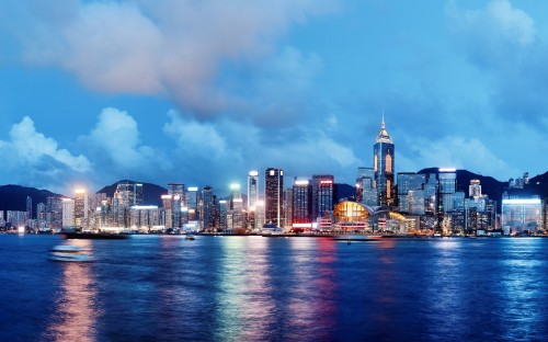 Image city skyline across body of water during daytime