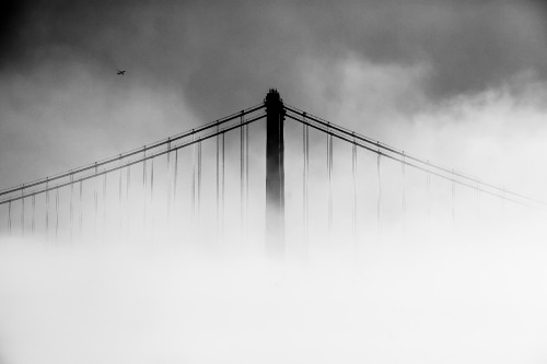 Image grayscale photo of bridge under cloudy sky