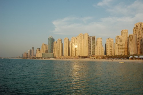 Image city skyline across body of water during daytime