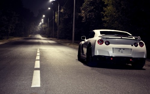 Image white and black porsche 911 on road during night time