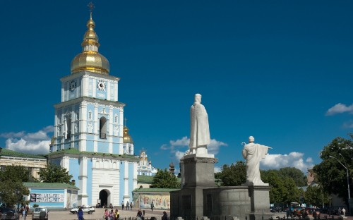 Image people walking on street near white and gold dome building during daytime