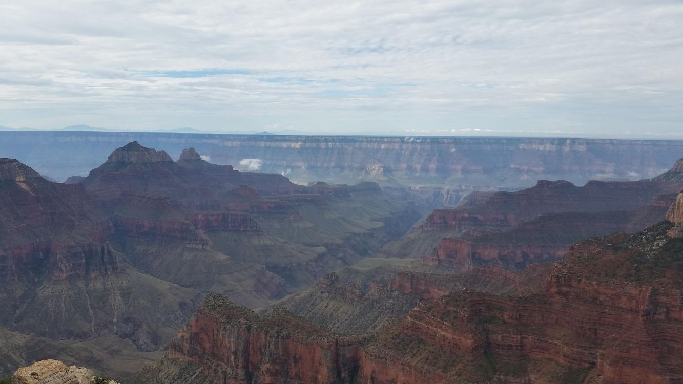 brown and gray mountains under white clouds during daytime