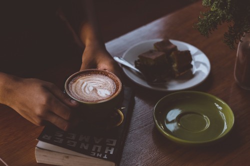 Image person holding cup of coffee