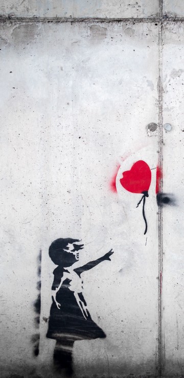 Image woman in black and white dress holding heart balloon