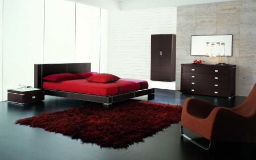 Image red and black bed near brown wooden cabinet