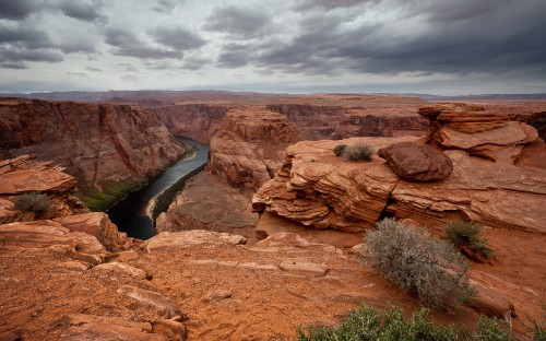 Image brown rock formation under gray clouds during daytime