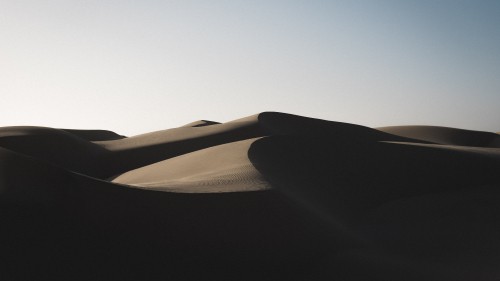 Image brown sand dunes under blue sky during daytime