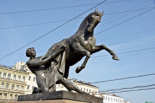 Image man riding horse statue under blue sky during daytime