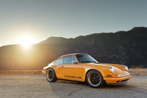 Image yellow porsche 911 on brown dirt road during daytime