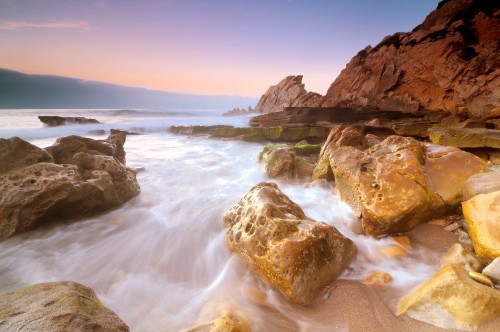 Image brown rock formation on sea during daytime