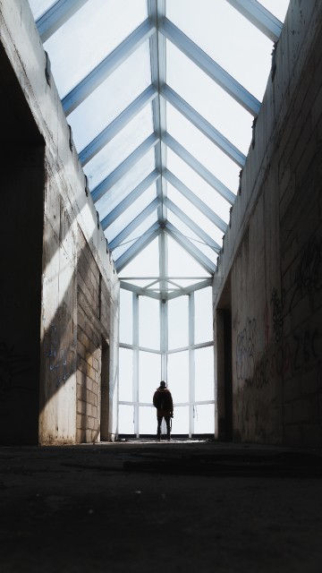 Image person walking on hallway during daytime