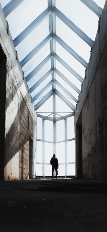 Image person walking on hallway during daytime