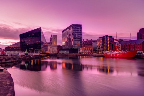 Image city skyline near body of water during sunset