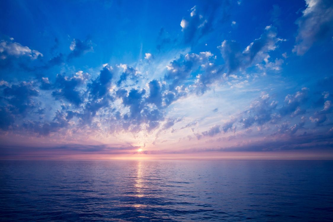 blue sky and white clouds over the sea