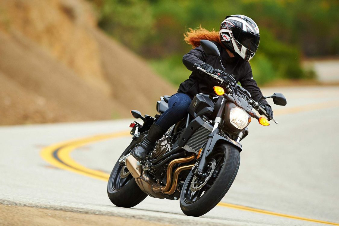 man in black jacket riding motorcycle on road during daytime