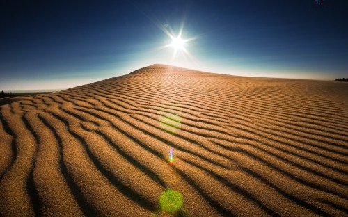 Image brown sand under blue sky during daytime