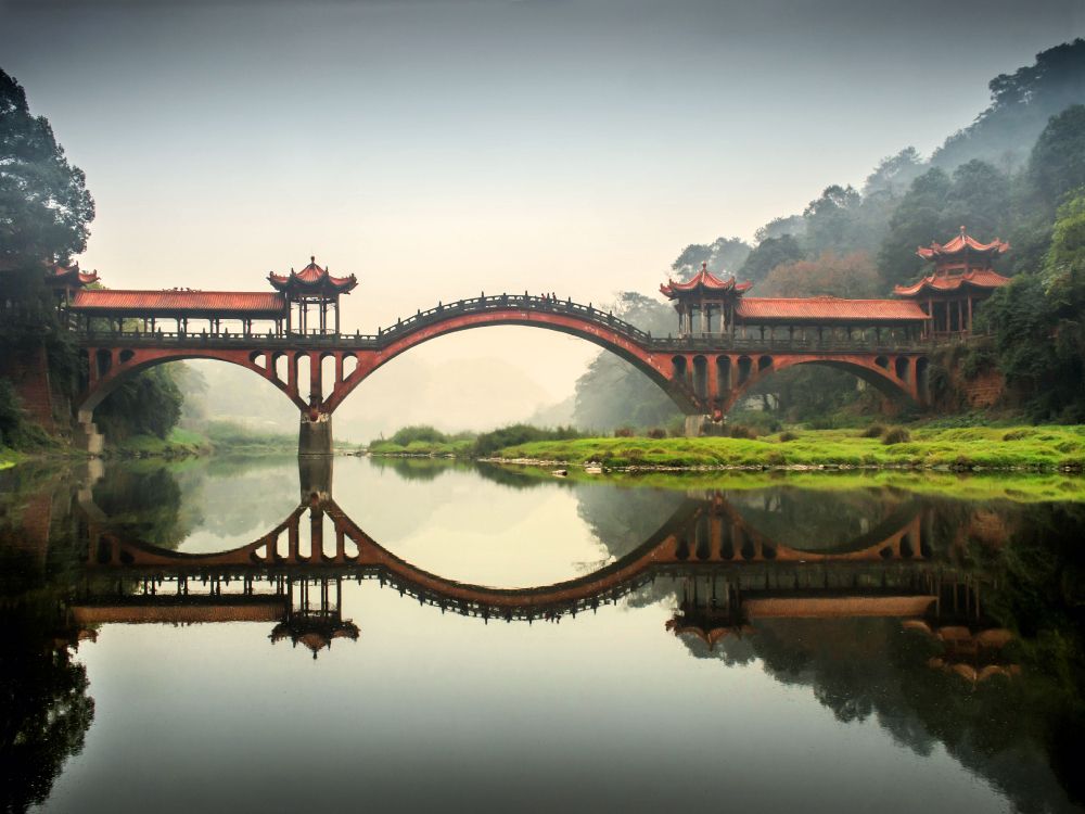 brown bridge over body of water