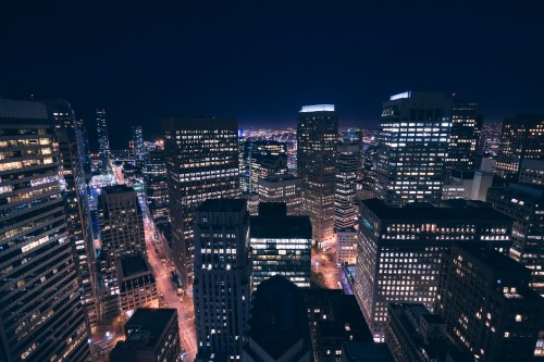 Image city with high rise buildings during night time