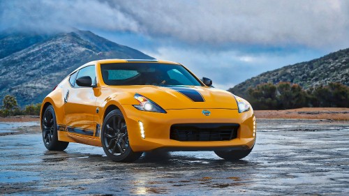 Image orange chevrolet camaro on gray asphalt road during daytime