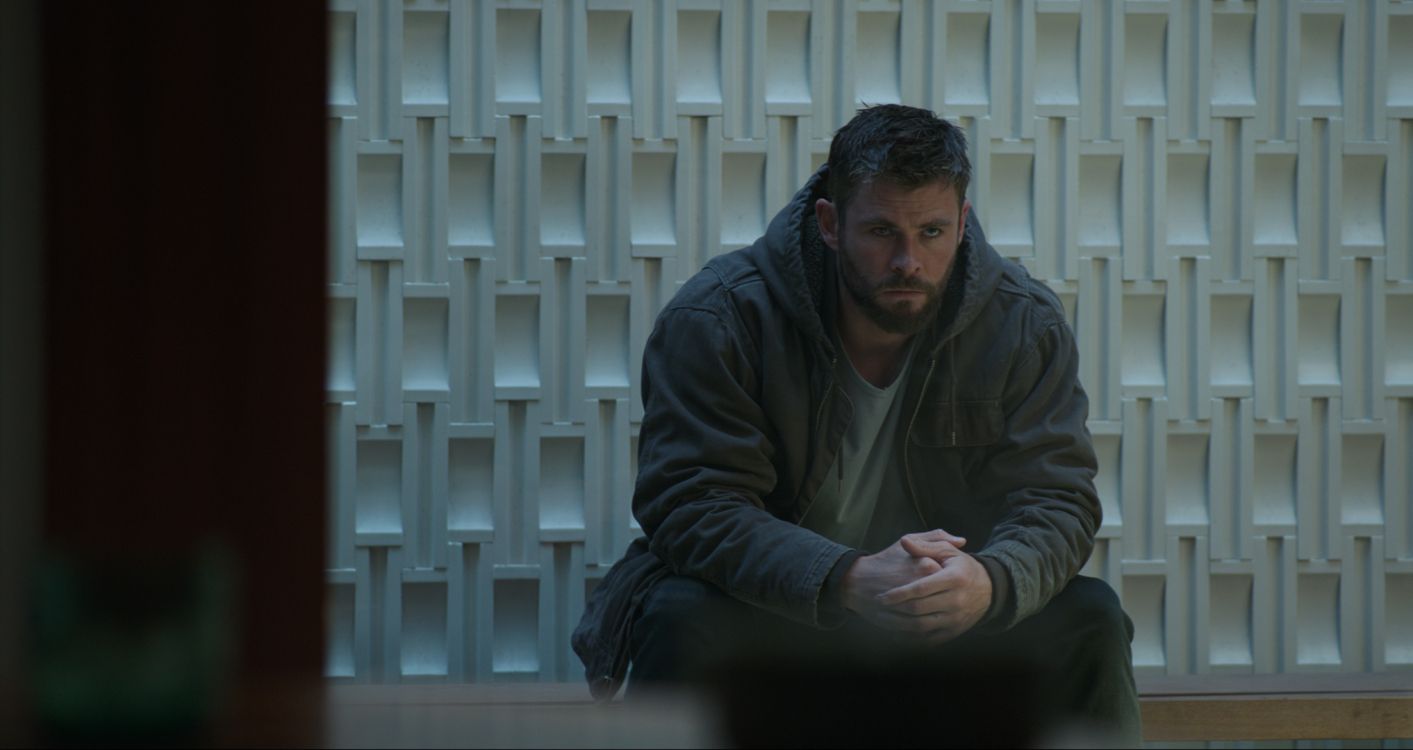 man in gray jacket sitting on black chair