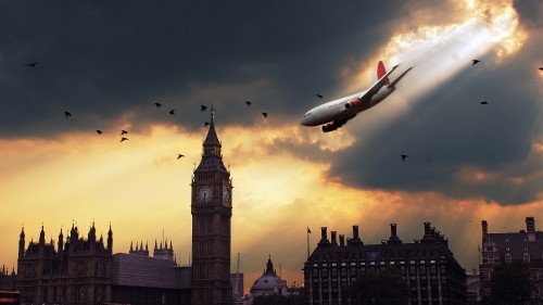 Image white and red airplane flying over the city during sunset