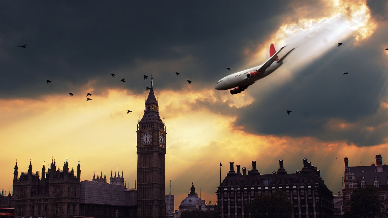 white and red airplane flying over the city during sunset