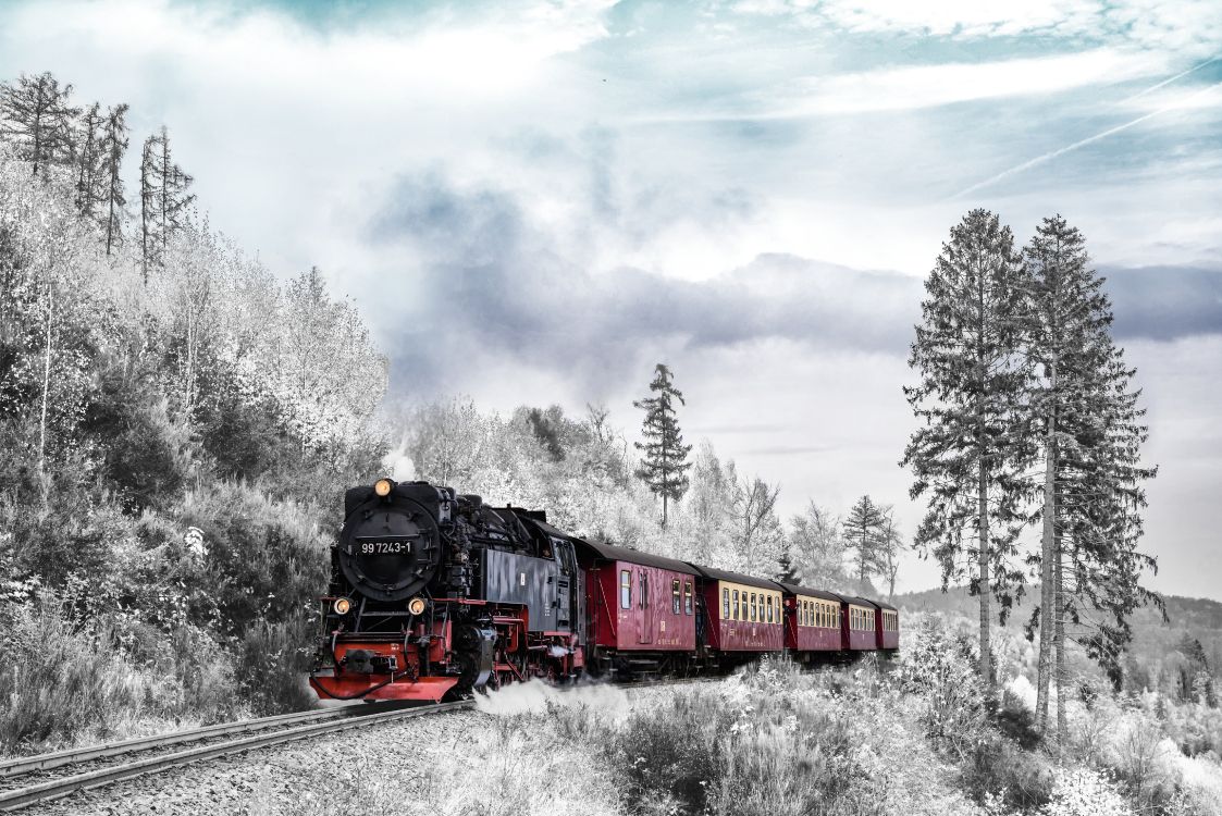 Red and Black Train on Rail Tracks Under Cloudy Sky. Wallpaper in 5556x3709 Resolution