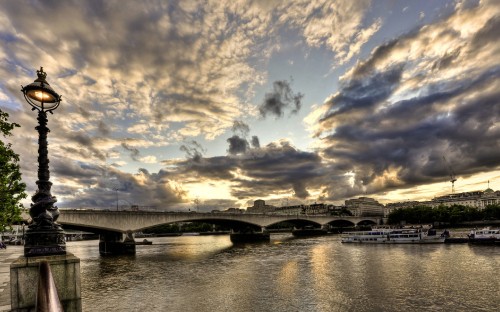 Image gray concrete bridge over river under blue sky and white clouds during daytime