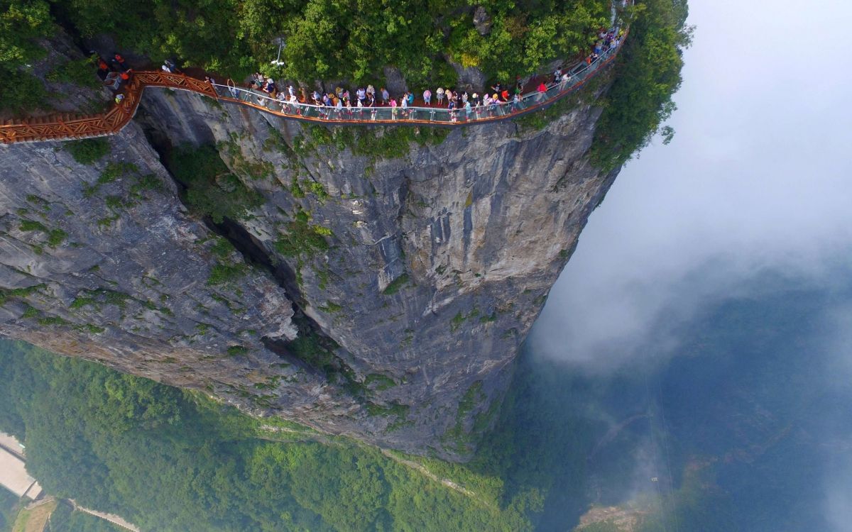 people walking on bridge over the river