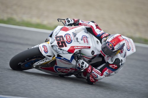 Image man in red and white racing suit riding on red and white sports bike