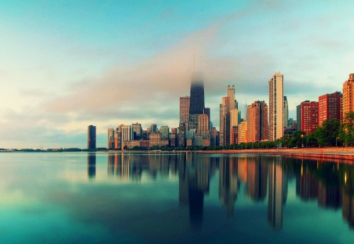 Image city skyline across body of water during daytime