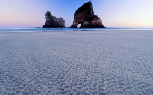 Image brown rock formation on blue sea during daytime