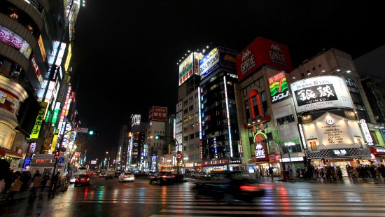 Image cars on road near buildings during night time