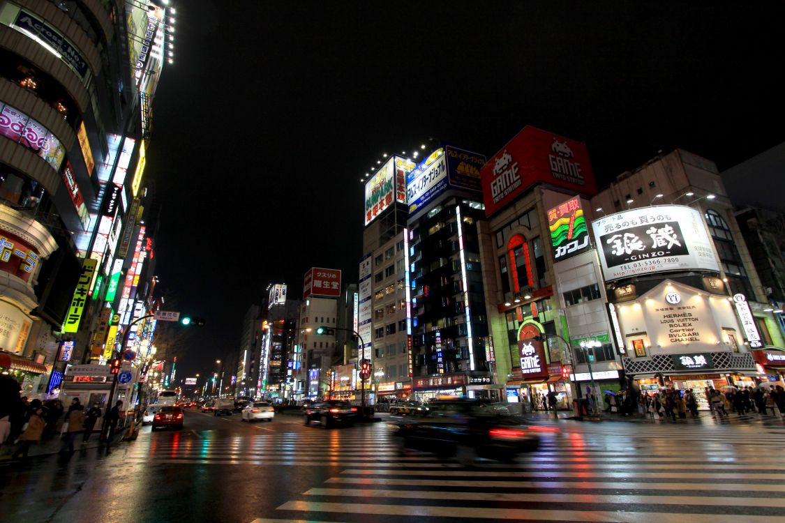 cars on road near buildings during night time