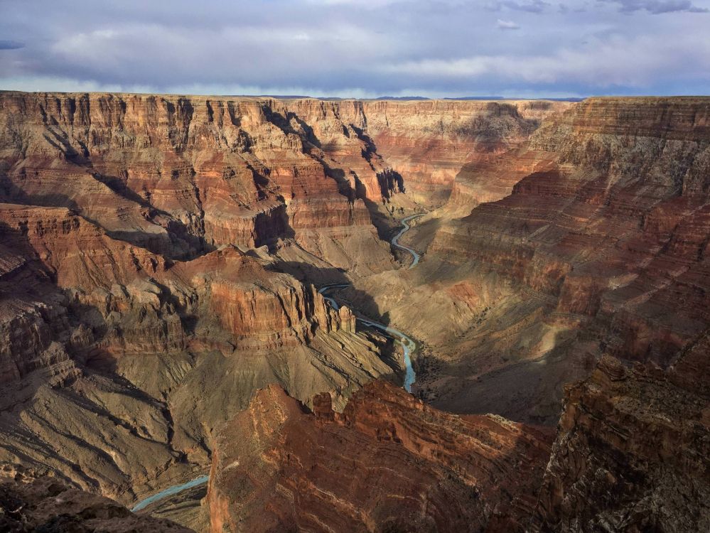 brown rock formation under gray sky during daytime