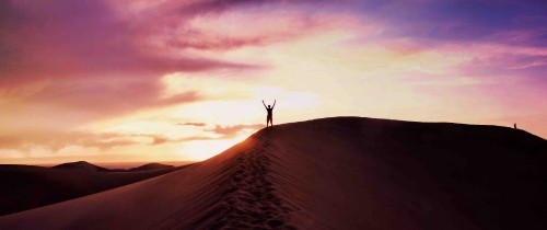 Image person standing on brown sand during daytime