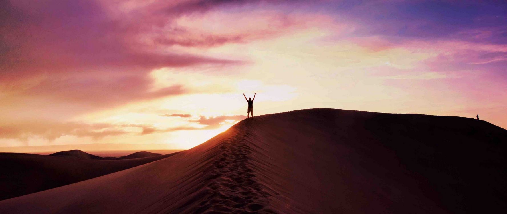 person standing on brown sand during daytime