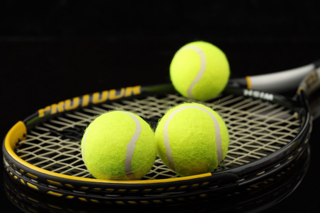 green tennis ball on black net