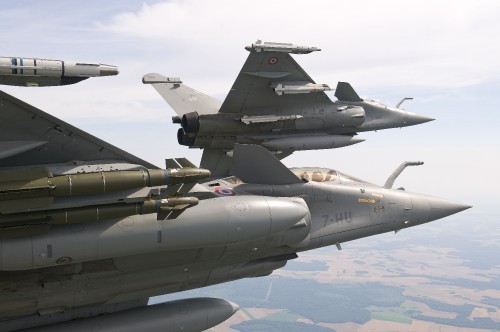 Image gray fighter jet flying over blue sky during daytime