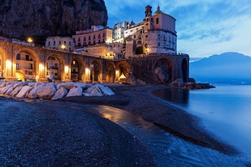 Image brown concrete building near body of water during night time