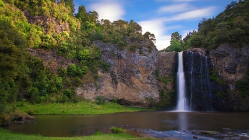 Image waterfalls on brown rocky mountain under blue sky during daytime