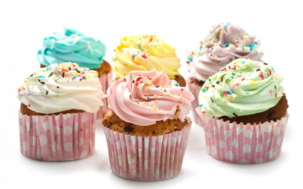 cupcakes with yellow pink and green icing on top