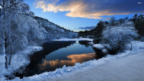 Image snow covered mountain near lake under blue sky during daytime